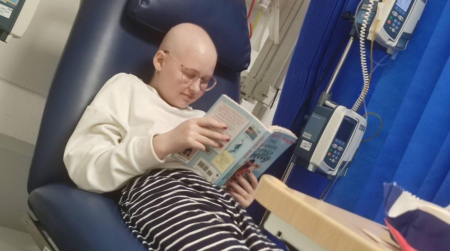Keira pictured in the hospital while undergoing treatment, reading a book